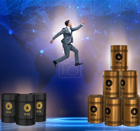 Photo for The businessman jumping from stack of oil barrels - Royalty Free Image
