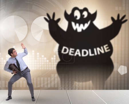 Photo for Businessman missing important deadline with the monster - Royalty Free Image