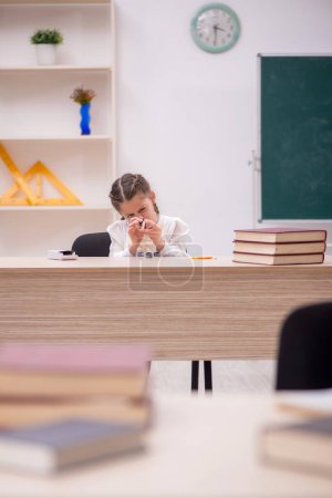 Photo for Little girl sitting in the classroom - Royalty Free Image