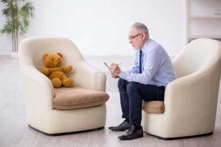 Photo for Old psychologist and soft bear in the room - Royalty Free Image