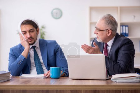 Photo for Young businessman employee suffering from toothache in the office - Royalty Free Image