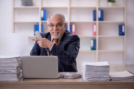 Photo for Old businessman employee unhappy with excessive work in the office - Royalty Free Image