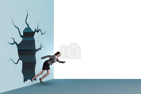 Photo for Businesswoman breaking through a wall - Royalty Free Image