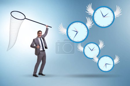 Foto de Concepto de fecha límite con el hombre de negocios la captura de relojes - Imagen libre de derechos