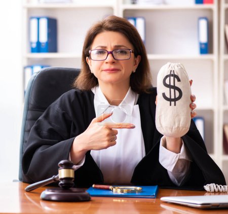 Photo for The middle-aged female doctor working in courthouse - Royalty Free Image