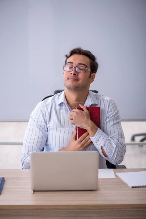 Photo for Young male teacher in front of whiteboard - Royalty Free Image