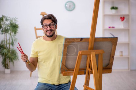 Photo for Young male painter enjoying painting at home - Royalty Free Image