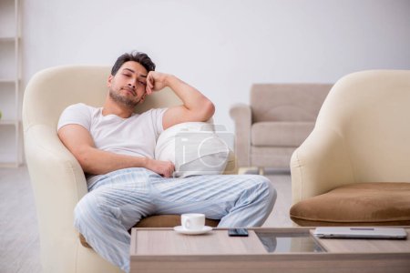 Photo for Young lazy man starting day at home - Royalty Free Image