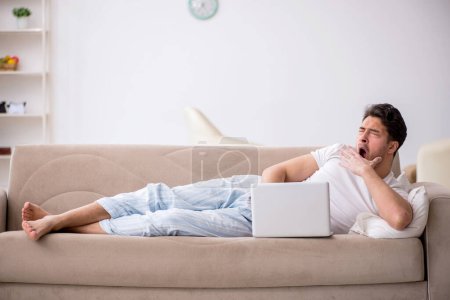 Photo for Young lazy man starting day at home - Royalty Free Image
