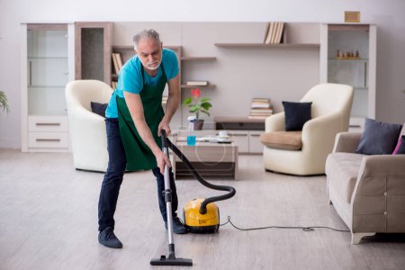 Photo for Old contractor cleaning the house - Royalty Free Image