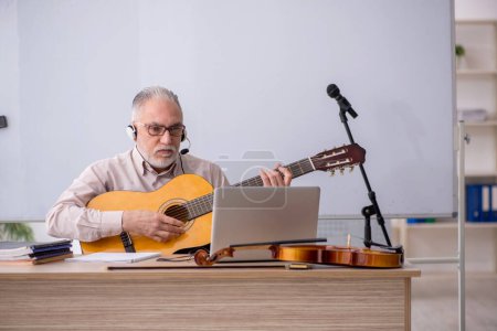 Photo for Old music teacher in the classroom - Royalty Free Image