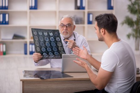 Photo for Young patient visiting old male doctor radiologist - Royalty Free Image