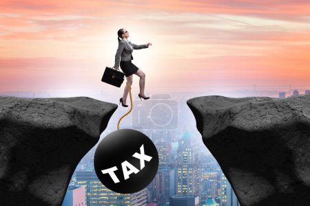 Photo for Concept of tax burden with businesswoman over the chasm - Royalty Free Image