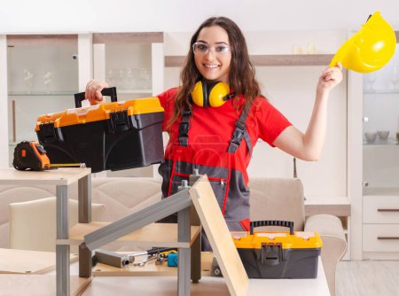 Photo for The female contractor repairing furniture at home - Royalty Free Image