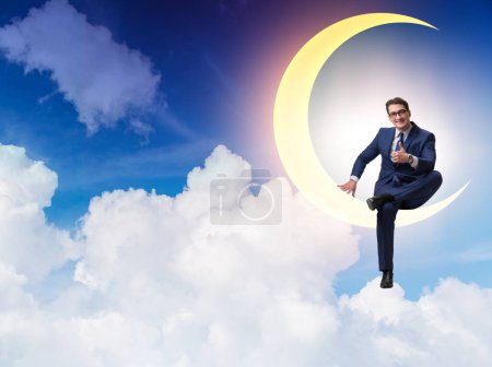 Téléchargez les photos : L'homme d'affaires assis sur le croissant de lune - en image libre de droit