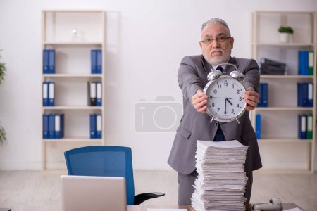 Photo for Old employee in time management concept - Royalty Free Image