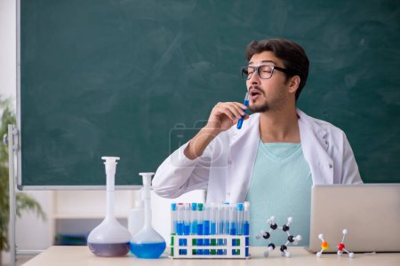 Photo for Young chemist in front of blackboard - Royalty Free Image