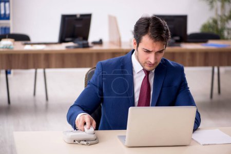 Photo for Young businessman employee working at workplace - Royalty Free Image