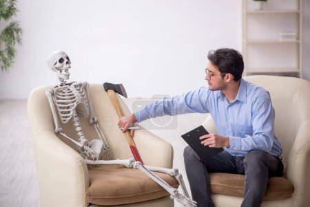 Photo for Young psychologist meeting with skeleton - Royalty Free Image