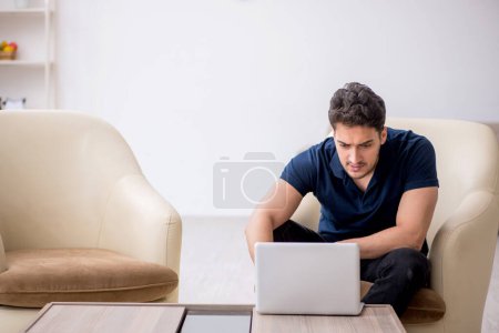 Photo for Young freelancer working from home during pandemic - Royalty Free Image