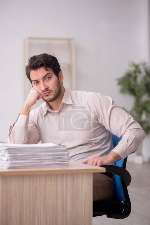 Photo for Young accountant sitting at workplace - Royalty Free Image