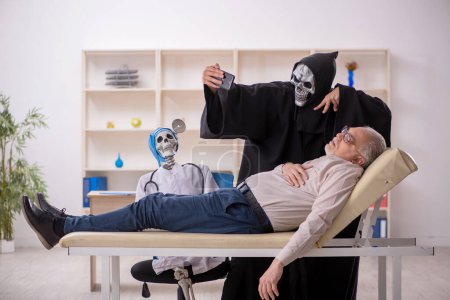 Photo for Old patient visiting two devil doctors - Royalty Free Image