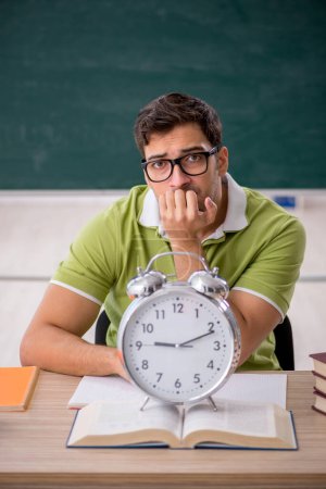 Photo for Young student in the classroom in time management concept - Royalty Free Image
