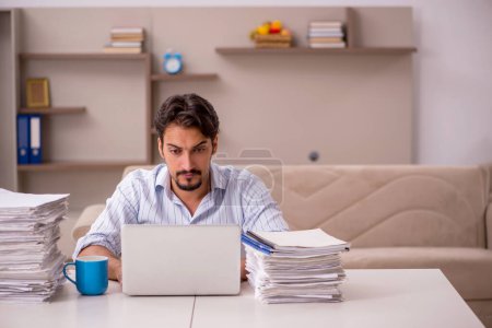 Photo for Young male employee working from home during pandemic - Royalty Free Image