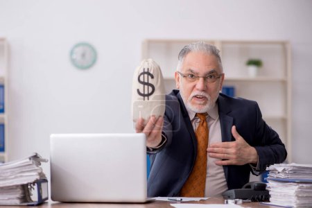 Photo for Old male employee holding moneybag - Royalty Free Image
