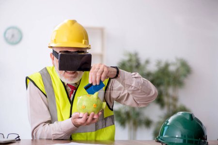 Photo for Old architect enjoying virtual glasses at workplace - Royalty Free Image