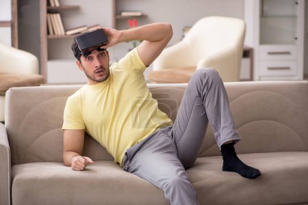 Photo for Young male student enjoying virtual glasses at home - Royalty Free Image