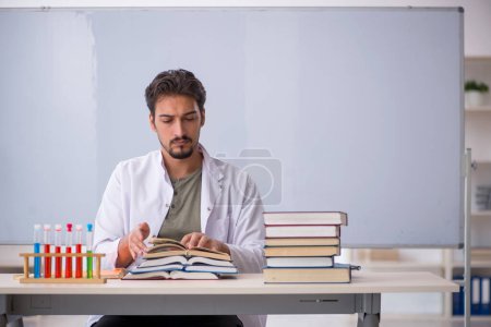 Photo for Young chemist teacher in front of whiteboard - Royalty Free Image