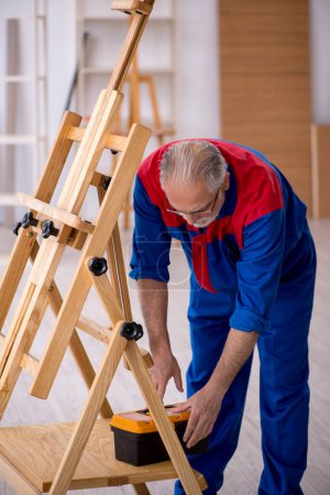 Photo for Old carpenter repairing drawing easel - Royalty Free Image