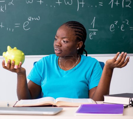 Photo for The black female student in front of chalkboard - Royalty Free Image