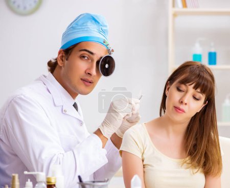 Photo for The young woman visting male doctor otolaryngologist - Royalty Free Image