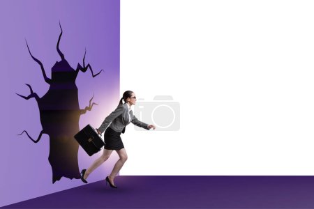 Photo for Businesswoman breaking through a wall - Royalty Free Image