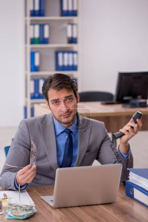 Photo for Young businessman employee talking by phone - Royalty Free Image