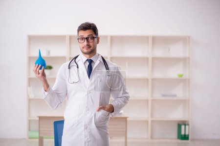 Photo for Young doctor gastroenterologist suggesting enema - Royalty Free Image