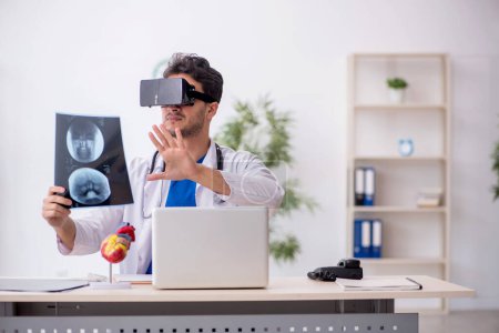 Photo for Young doctor enjoying virtual glasses in the clinic - Royalty Free Image