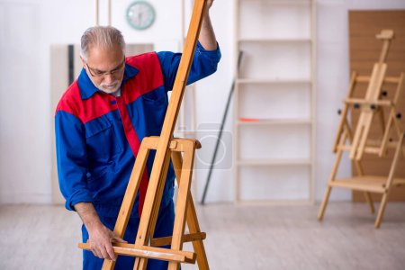 Photo for Old carpenter repairing drawing easel - Royalty Free Image