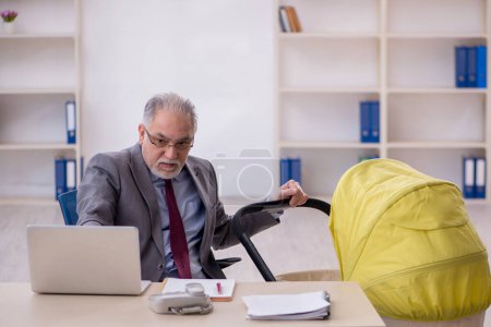 Photo for Old businessman employee looking after new born in the office - Royalty Free Image
