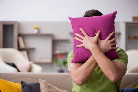 Photo for Young man with a lot of pillows at home - Royalty Free Image