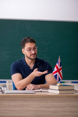 Photo for English language teacher in front of green board - Royalty Free Image