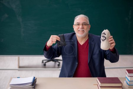 Photo for Old teacher in remuneration concept - Royalty Free Image
