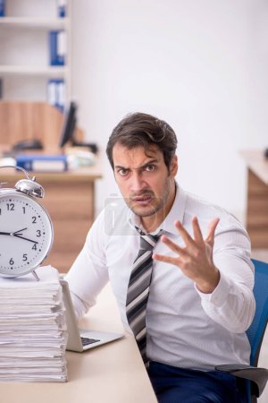Photo for Young businessman employee in time management concept - Royalty Free Image