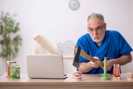 Photo for Old dentist working at the hospital - Royalty Free Image