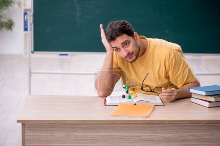 Photo for Young student physicist sitting in the classroom - Royalty Free Image