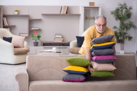 Photo for Aged man with many pillows at home - Royalty Free Image