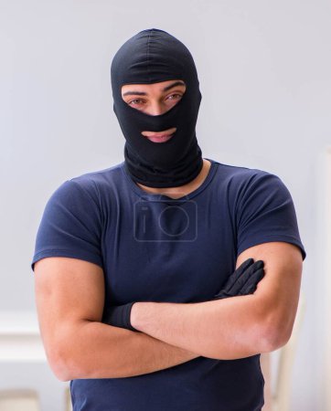 Photo for The robber wearing balaclava stealing valuable things - Royalty Free Image