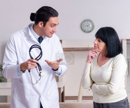 Photo for The young doctor examining senior old woman - Royalty Free Image